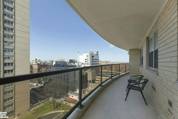 Balcony view of cityscape with surrounding buildings.