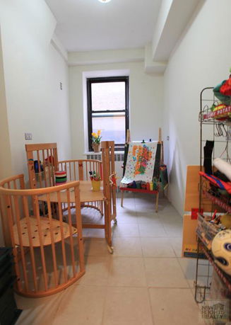 Small indoor play area with table and painting easel