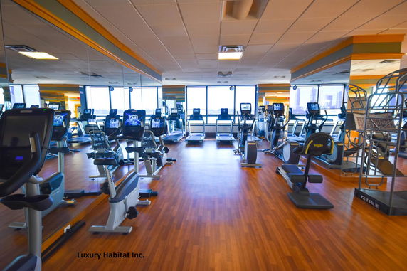 Indoor fitness area with various exercise machines.