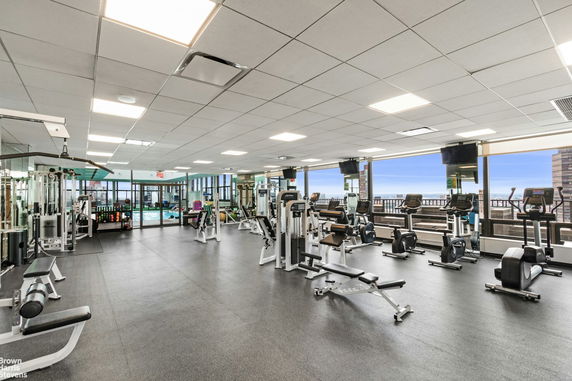 Interior view of a gym with exercise machines and weight equipment.