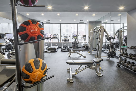 Interior view of a gym with exercise equipment and fitness machines.