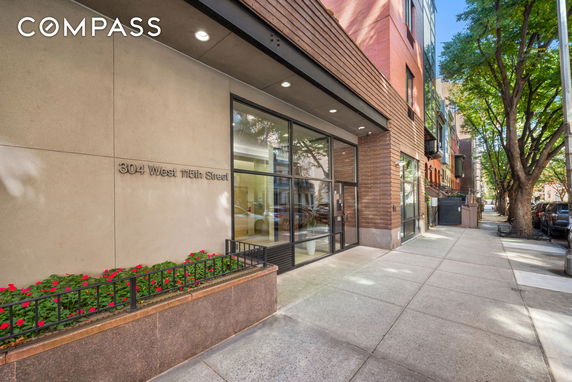 Front view of a building with large glass windows and an entrance.
