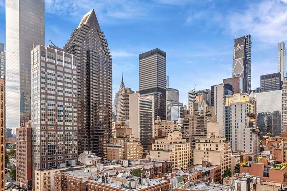 Skyline view of tall skyscrapers in a city with varied architectural styles.