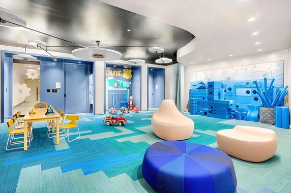 Indoor children's play area with colorful seating and toys.