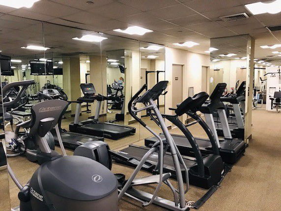 Indoor gym area with treadmills and exercise equipment.