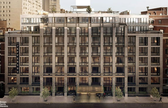 Front view of a multi-story building with large windows and a modern design.