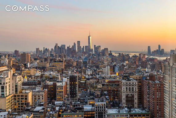 Panoramic view of a city skyline at sunset.