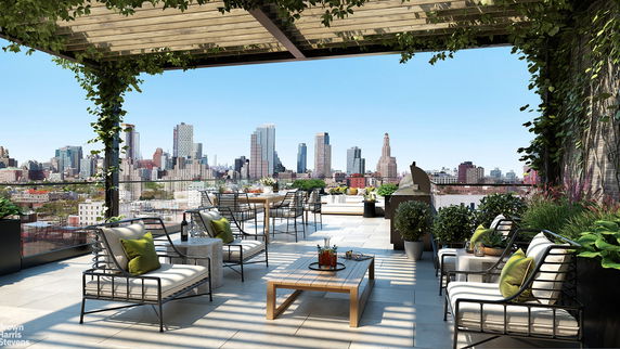 Rooftop terrace with outdoor furniture and city skyline view.