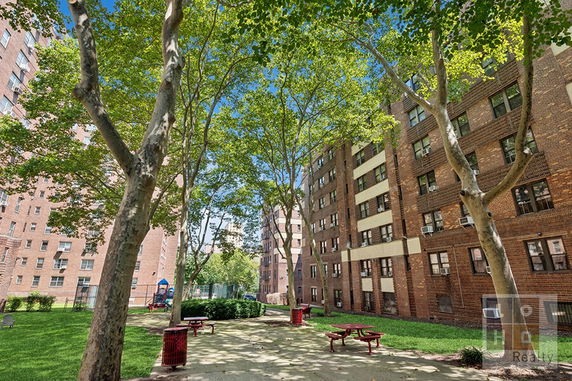 Exterior view of a brick building with multiple windows.