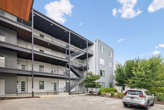 Front view of a multi-story building with open walkways and stairs.