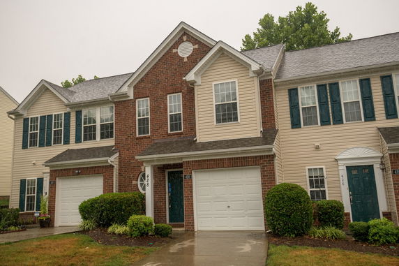 Front view of a two-story house with a double garage and brick facade.
