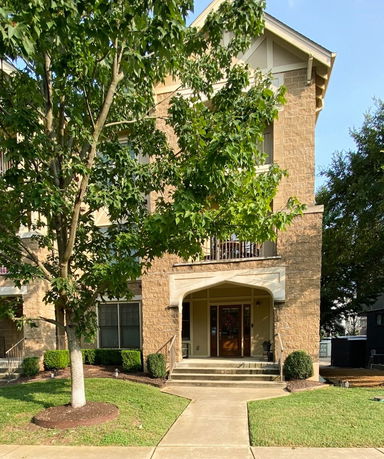 Front view of a multi-story house with a covered entrance.