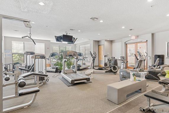 Interior view of a gym with various exercise equipment and machines.