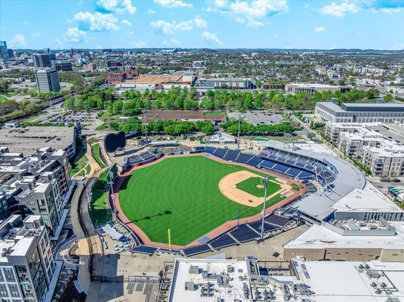 Aerial view of a baseball stadium surrounded by urban buildings.