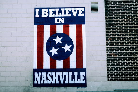 Front view of a wall with a mural saying 'I Believe In Nashville'.