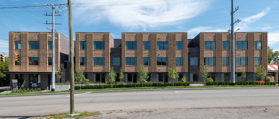 Front view of a modern three-story brick building.