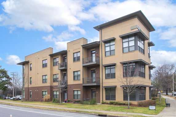 Front view of a multi-story residential building with balconies.
