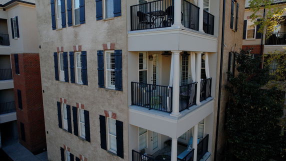 Front view of a multi-story building with balconies.