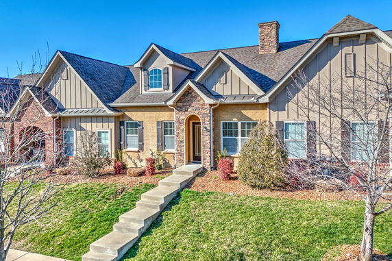 Front view of a house with gabled roof and stone accents.