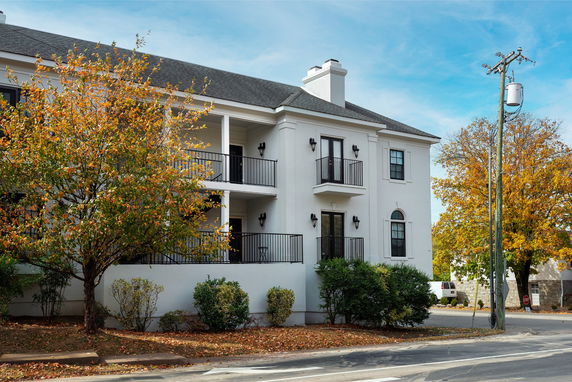 Front view of a two-story building with balconies.