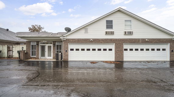 Front view of a house with a double garage and brick facade.