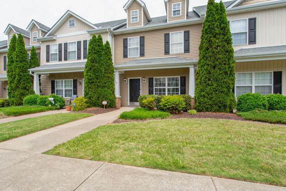 Front view of a two-story townhouse with a covered entrance.