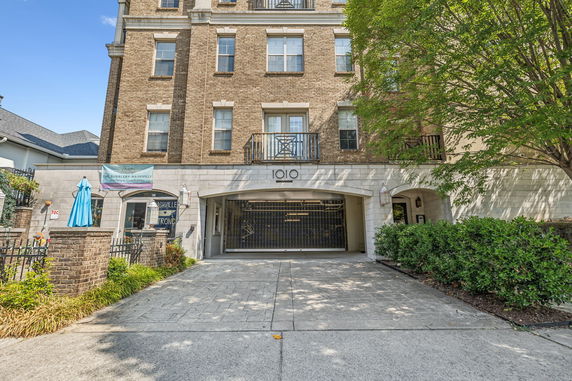 Front view of a multi-story brick building with an entrance and garage.