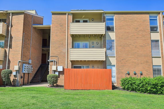 Front view of a multi-story apartment building with balconies.