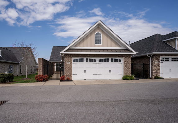 Front view of a house with a large double garage and a gabled roof.