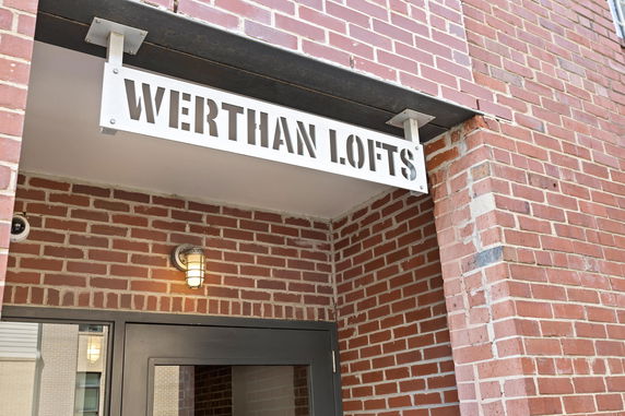 Brick exterior of a building with a sign reading 'Werthan Lofts' above the entrance.