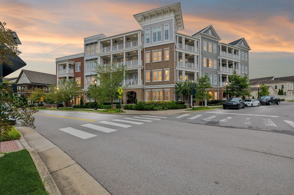 Front view of a multi-story building on a street corner.