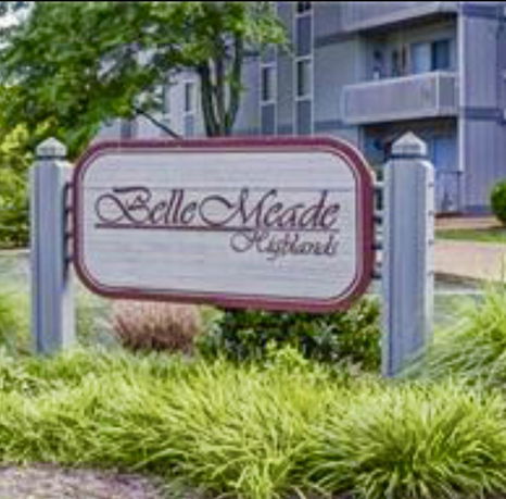 Front view of an apartment building with a sign reading 'Belle Meade'.