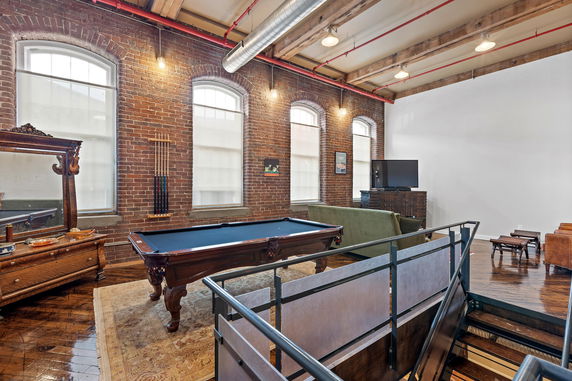Interior view of a room with a pool table and seating area.