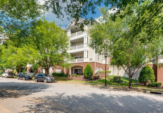 Front view of a multi-story residential building with balconies.