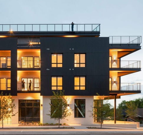 Front view of a multi-story modern building with balconies.