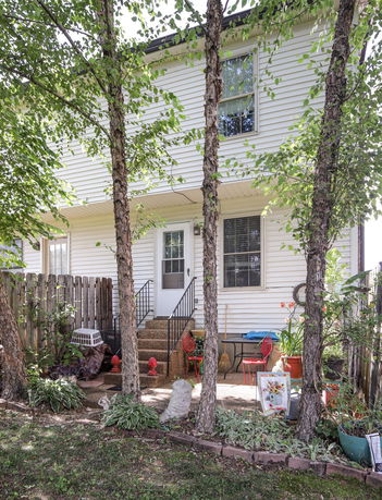 Front view of a two-story house with white siding.