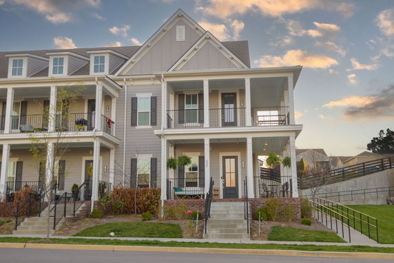 Front view of a multi-story house with balconies.