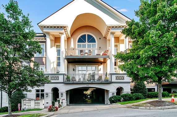 Front view of a building with large columns and balconies.