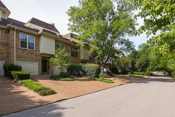 Front view of townhouses with brick exteriors and double garages.