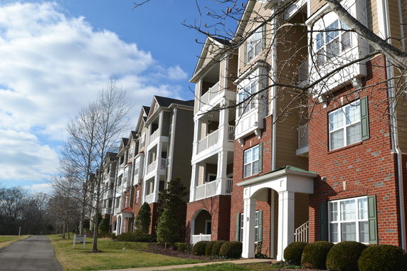 Front view of a multi-story apartment building with balconies.