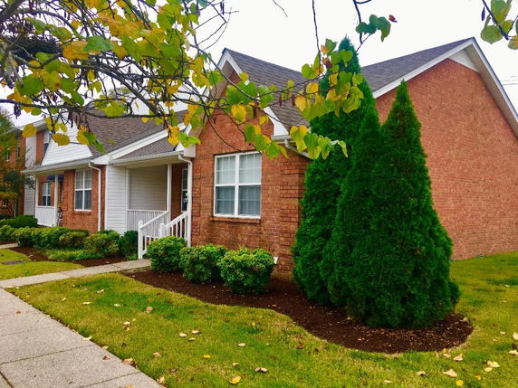 Front view of a single-story house with brick exterior and a small porch.
