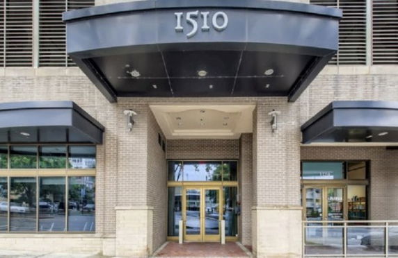 Front view of a building entrance with the number 1510 above the canopy.