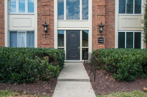 Front view of a brick multi-story building with a central entrance.