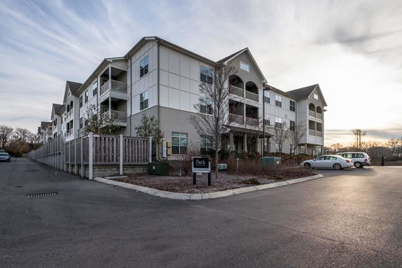 Front view of a multi-story apartment building with balconies.