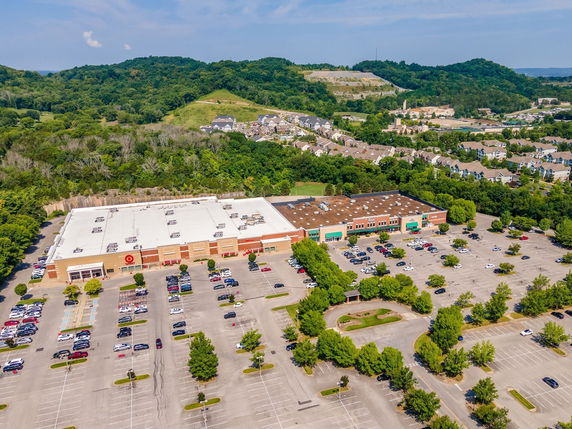 Aerial view of a large commercial building with a spacious parking area.