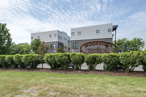 Front view of modern apartment buildings with flat roofs and large windows.