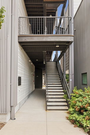 Front view of a multi-level building with external staircase.