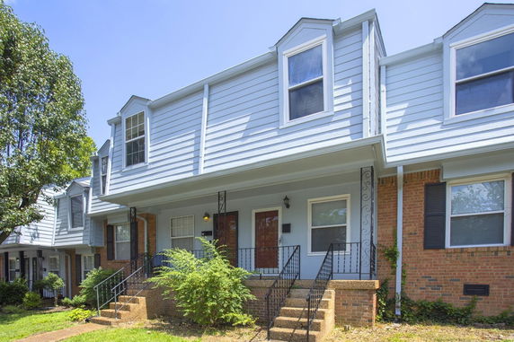 Front view of a two-story house with brick and siding exterior.