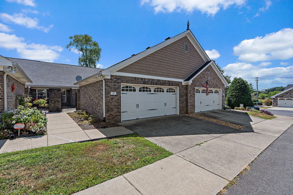 Front view of a house with a double garage and brick exterior.