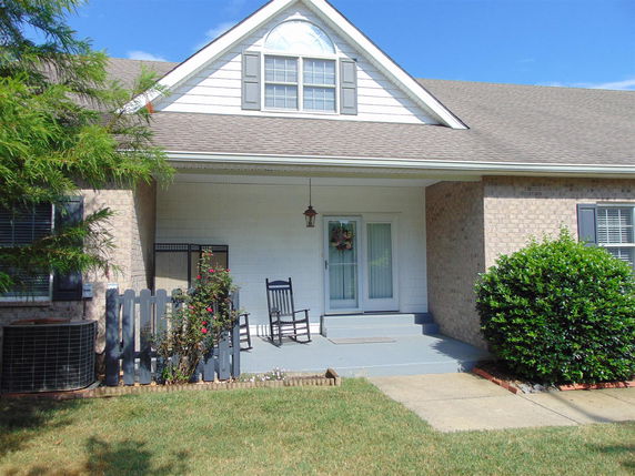 Front view of a house with a gable roof and a porch.
